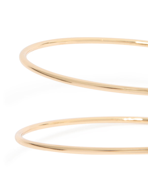 Gold sun and swirl arm cuff with celestial design close up view