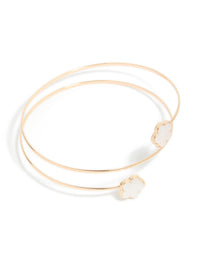 Showcasing a gold small flower arm cuff featuring floral accents in white in front view - link has visual effect only