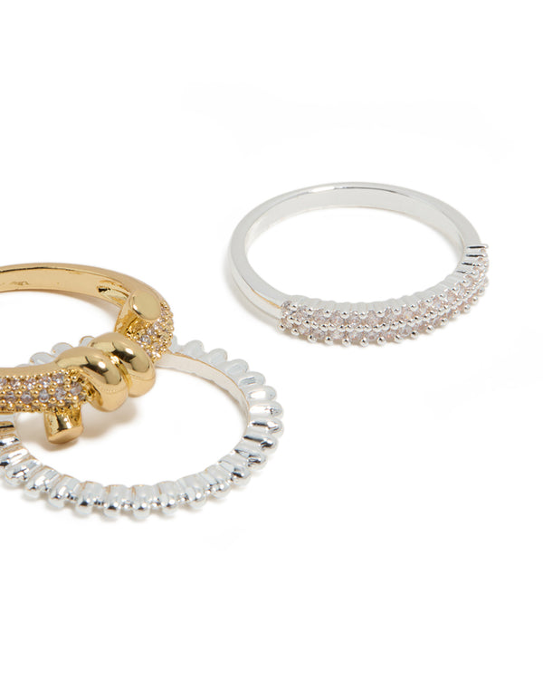 Featuring mixed metal plated cubic zirconia knotted textured rings 4-pack in gold, silver, and clear stone close up view