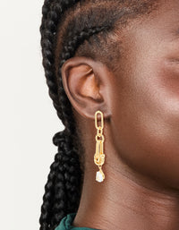 Discover these statement drop earrings crafted from gold plated metal featuring with knotted link design and cubic zirconia stones on ear view - link has visual effect only