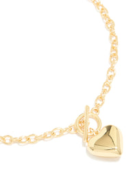 Featuring a gold plated heart charm necklace close up view - link has visual effect only