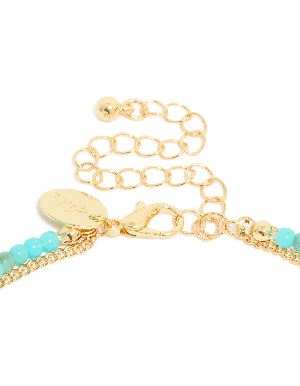 Crafted with gold plating and blue beads, this layered necklace has a celestial pendant featuring star detail and cubic zirconia in statement style clasp detail view