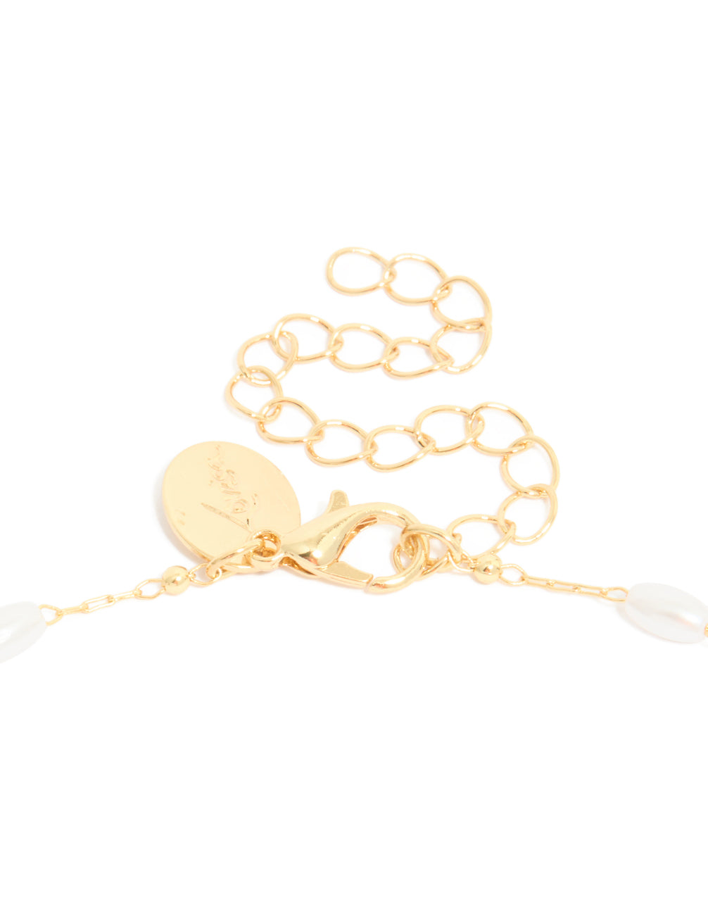 A gold plated cubic zirconia cross and pearl necklace clasp detail view