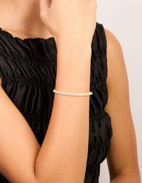 Showcasing a gold plated cubic zirconia pavé toggle bracelet with adjustable fastening on wrist view - link has visual effect only