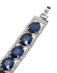 A statement bracelet in silver with blue diamantes, shown in closure detail view - link has visual effect only