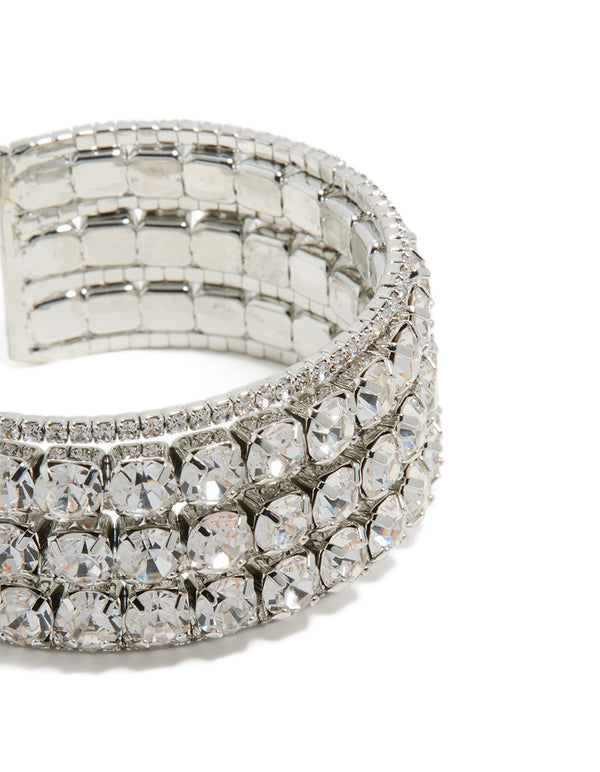 Featuring radiant diamantes, this large statement wrist cuff bangle in silver highlights intricate details in close up view