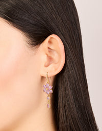 Showcasing gold pink cubic zirconia flower hook earrings, on ear view - link has visual effect only
