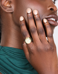Showcasing a gold and black watch ring with white dial, round shape, analog movement designed for women's casual wear in statement style on model view - link has visual effect only