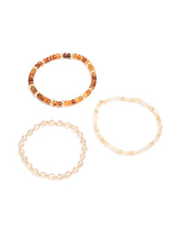 Elegant clear and brown beaded stretch bracelets 3-pack featuring gold accents front view - link has visual effect only