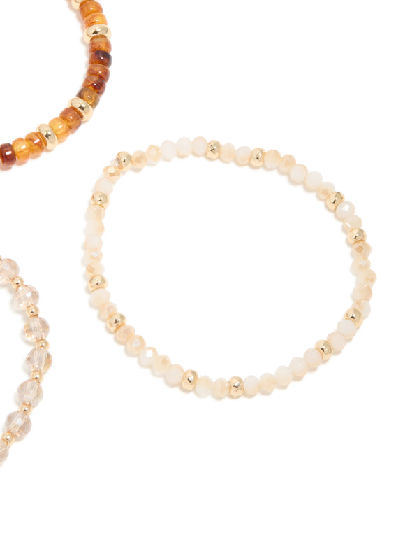 Featuring clear and brown beaded stretch bracelets in a 3-pack with gold accents close up view