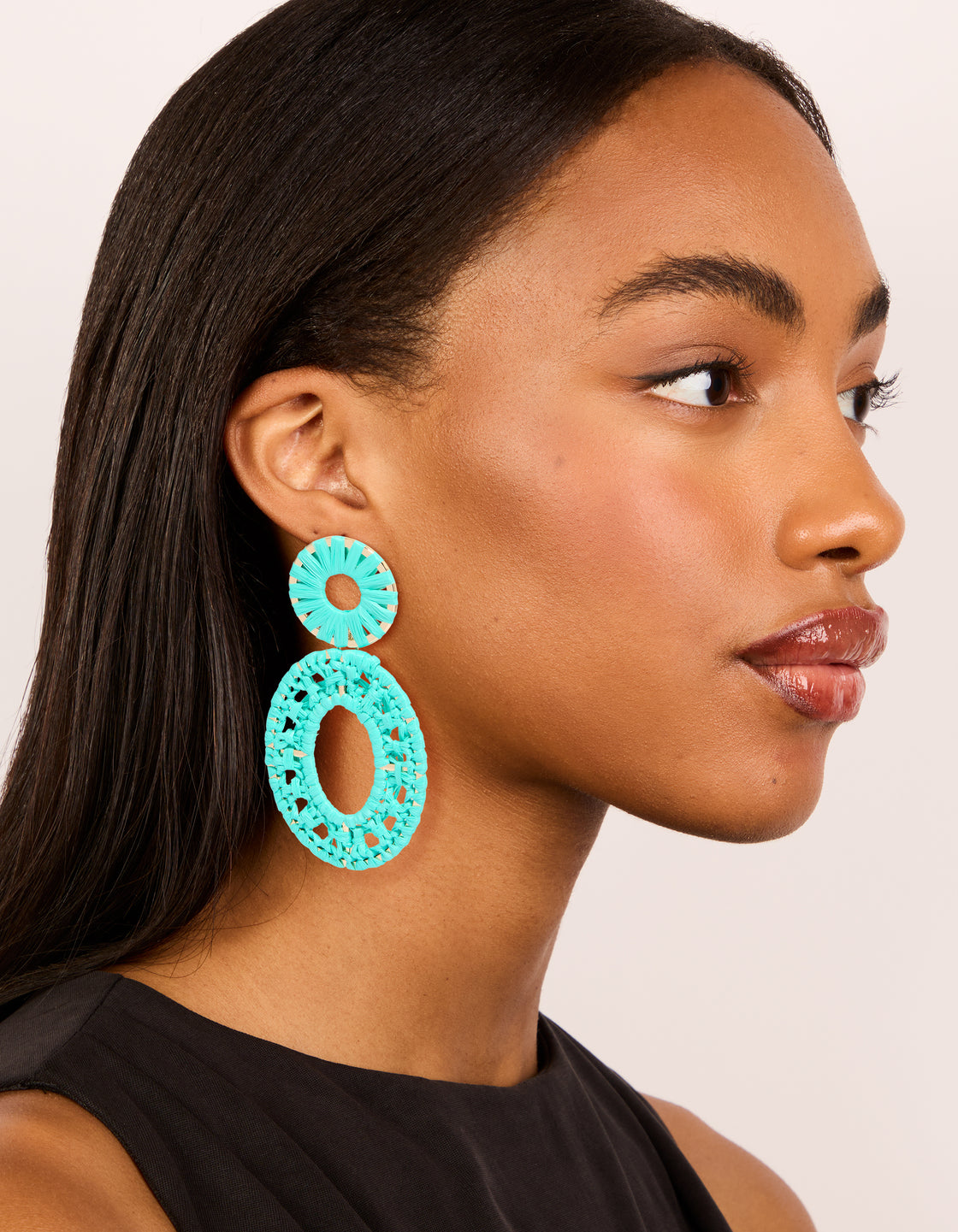 Elegant aqua blue paper patterned oval drop earrings with statement design on model view