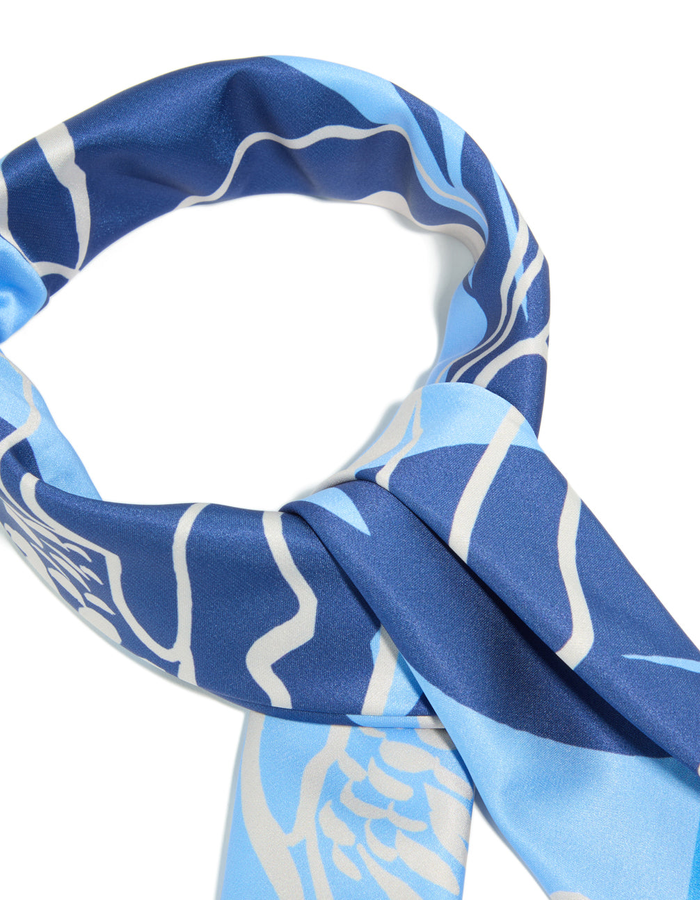 A closer look at this dark blue fabric scarf featuring grey flower outline dodger blue, navy, light blue and grey hues detail view