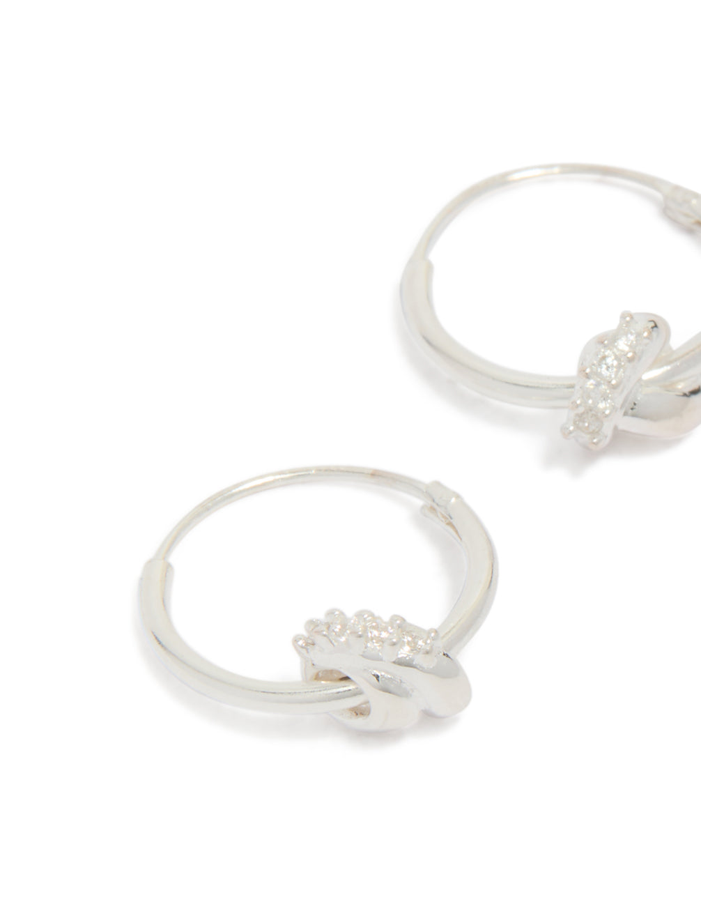 Featuring sterling silver cubic zirconia knotted hoop earrings with detailed craftsmanship in close up view