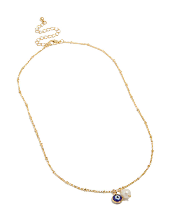 Highlighting a gold plated brass necklace with evil eye charm and pearl pendant front view