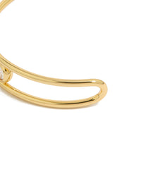 Designed with gold plated brass and bezel set cubic zirconia, this statement bangle wrist cuff highlights the closure detail view - link has visual effect only