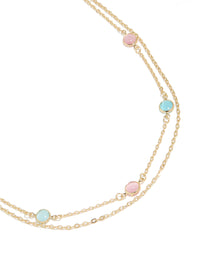 Elegant gold plated layered necklace featuring pink and blue stones details in a statement style close up view - link has visual effect only