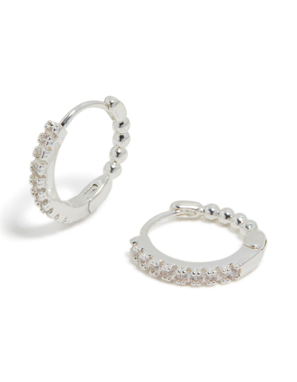 Showcasing skinny huggie earrings crafted from silver plated material featuring cubic zirconia front view
