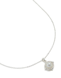 Showcasing a silver plated cubic zirconia pearl centre pendant necklace close up view - link has visual effect only