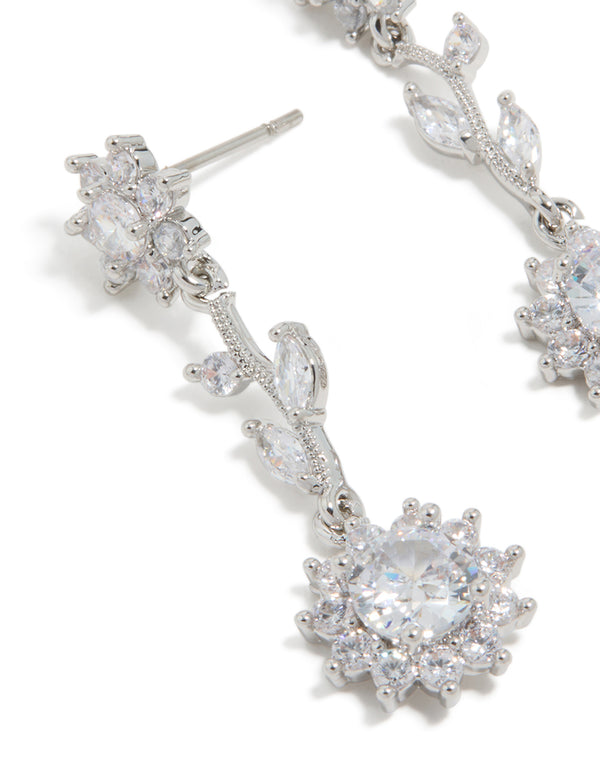 Highlighting silver cubic zirconia vine floral drop earrings with leaf design close up view