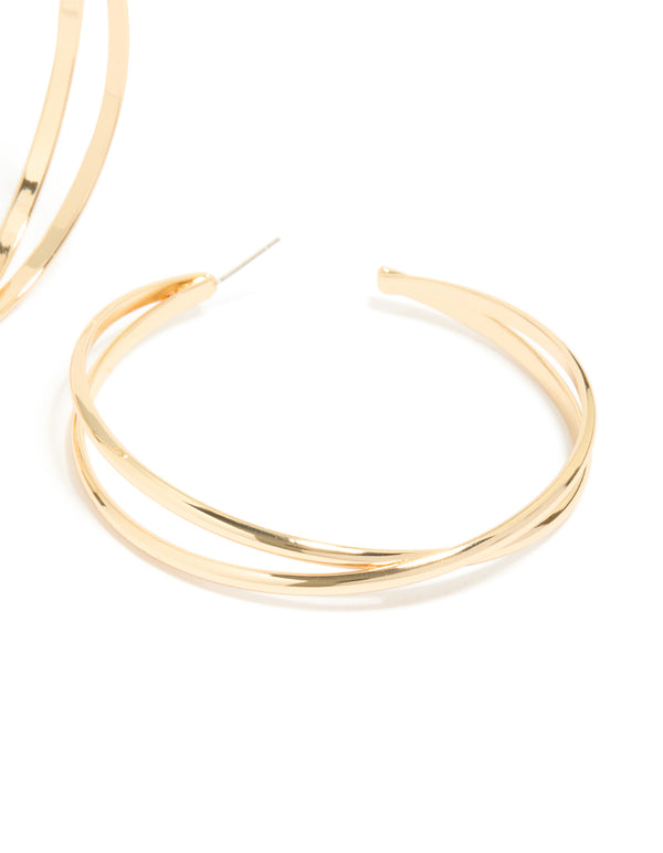 Crafted from gold, large crossover hoop earrings with post fastening post detail view