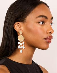 Crafted with gold ribbed shell and pearls charm drop earrings featuring ocean theme in statement style on model view - link has visual effect only