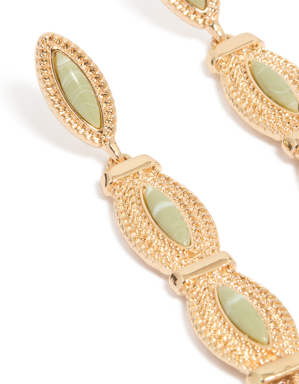 Beautifully crafted pale green stone set in gold with intricate detailing close up view