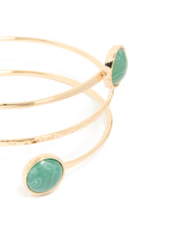 Featuring a gold statement arm cuff with teal stones close up view - link has visual effect only