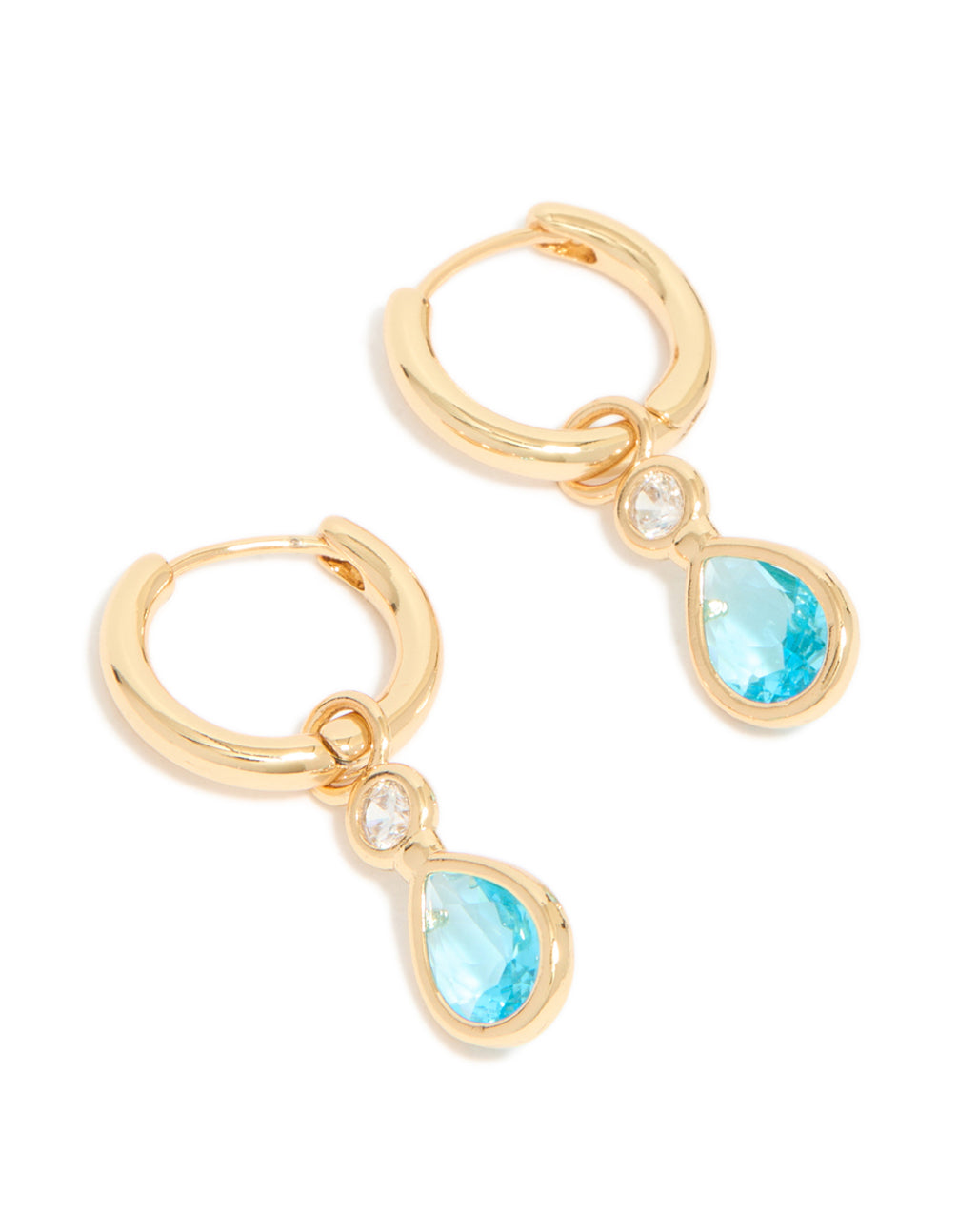 Crafted from gold plated material, these blue cubic zirconia teardrop huggie earrings showcase a design with hoop closure front view