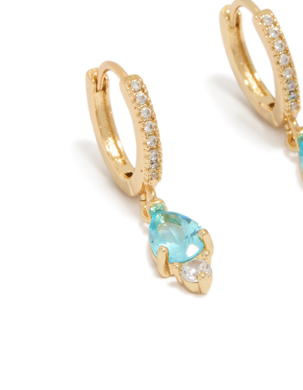 Featuring gold plated blue cubic zirconia huggie earrings close up view