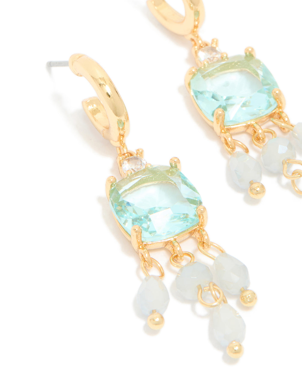 Highlighting gold plated blue cubic zirconia square drop earrings with stone and bead details, accented with charms in a statement style, close up view
