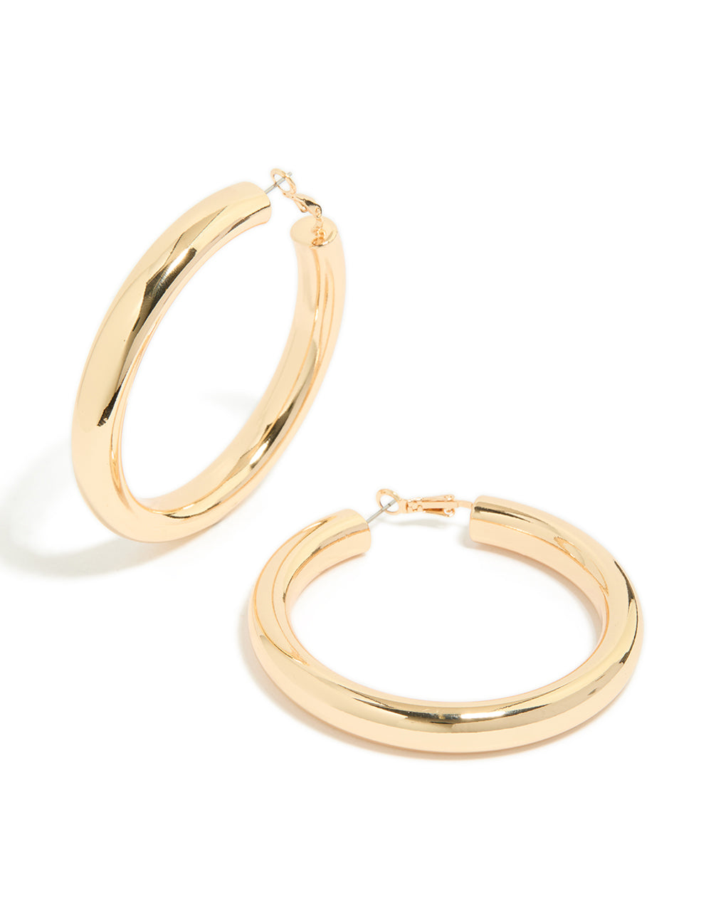 Showcasing gold large thick hoop earrings with statement style in a front view