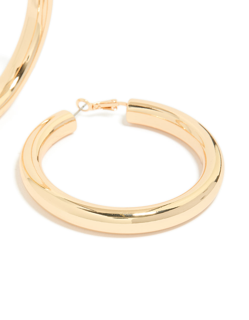 Crafted from gold, these large thick hoop earrings feature statement style in a post detail view