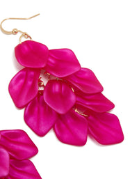 Highlighting fuchsia pink coated metal petal drop statement earrings with gold hook detail view - link has visual effect only