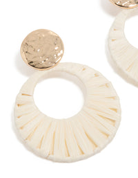 Featuring statement drop earrings with gold hammered studs and white raffia paper circle drops in ivory and wheat tones close up view - link has visual effect only