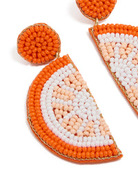 Showcasing orange seed beaded fruit drop earrings with statement style in white, peachpuff, and gold close up view - link has visual effect only