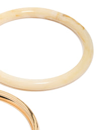Showcasing gold and blue acrylic stackable bangle bracelets in a 4-pack close up view - link has visual effect only