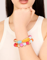 Showcasing acrylic beaded stretch bracelets in orange, pink, light blue, and gold in a 2-pack on wrist view - link has visual effect only