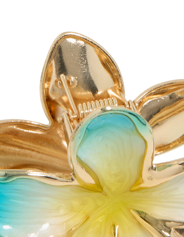 Crafted from floral enamel, this frangipani flower claw clip in turquoise, yellow, and gold detail view
