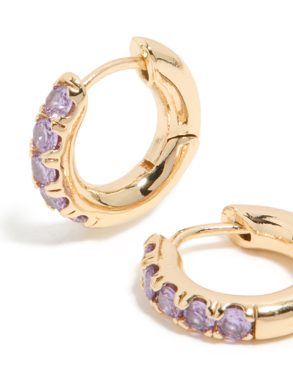 Elegant small clicker earrings in gold with light purple cubic zirconia and huggie closure close up view