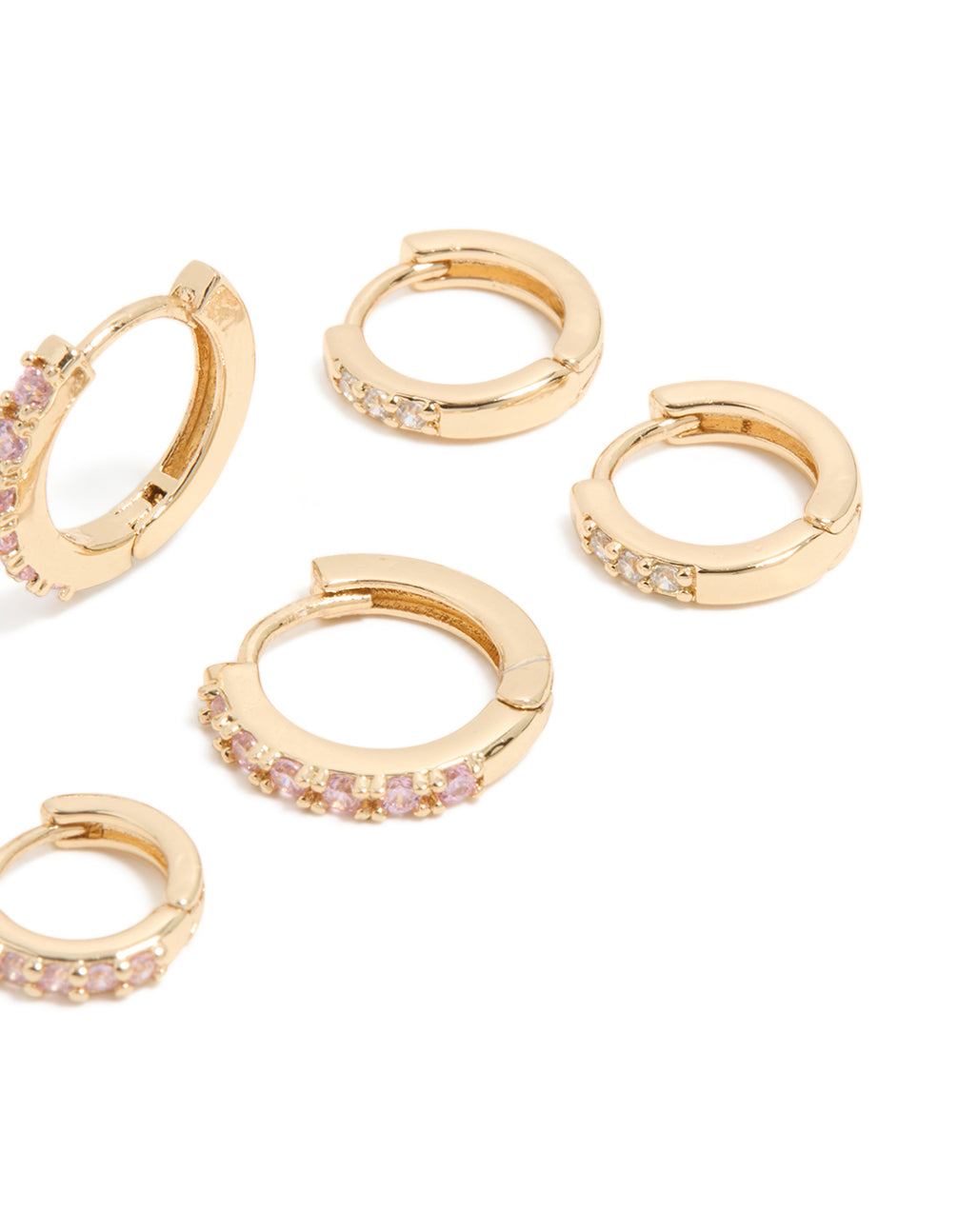 Crafted from cubic zirconia in gold with light pink accents, these simple huggie earrings come as a 3-pack post detail view