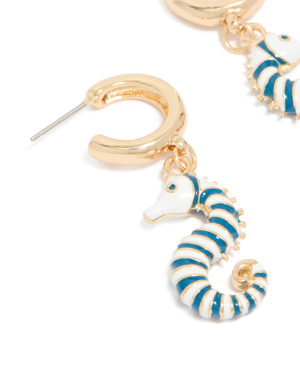 Revealing gold hoop earrings with teal and white seahorse in ocean-inspired styling close up view