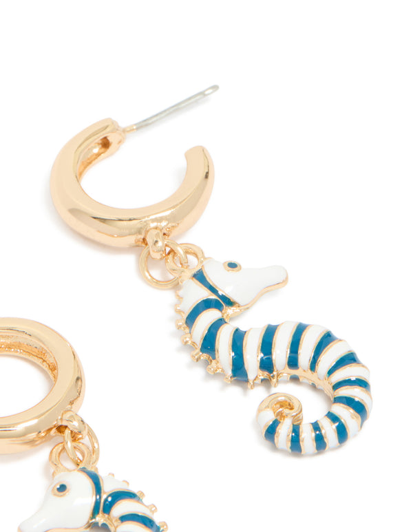 Revealing gold hoop earrings with teal and white seahorse in ocean-inspired styling close up view