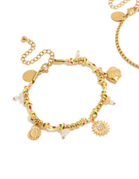 Featuring waterproof gold plated stainless steel freshwater pearl and multicoloured cord charm bracelets with celestial sun, shell, coin, rose quartz, and beads in a 2-pack close up view - link has visual effect only