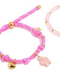 Displaying waterproof gold plated stainless steel semi precious stone and sea cord bracelets in a 2-pack with beads, heart and ocean charm, rose quartz accents close up view - link has visual effect only