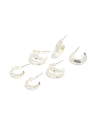 Showcasing silver chubby and textured huggie earrings in a 3-pack front view - link has visual effect only