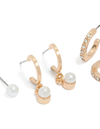 Featuring dainty gold pearl and diamante huggie and stud earrings in a 3-pack close up view - link has visual effect only