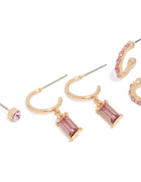Showcasing gold hoop and stud earrings in a 3-pack with light pink diamante details close up view - link has visual effect only