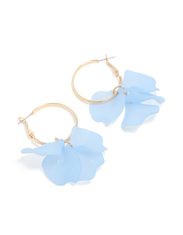Featuring floral hoop earrings in gold with light blue acrylic petal drops and statement styling front view