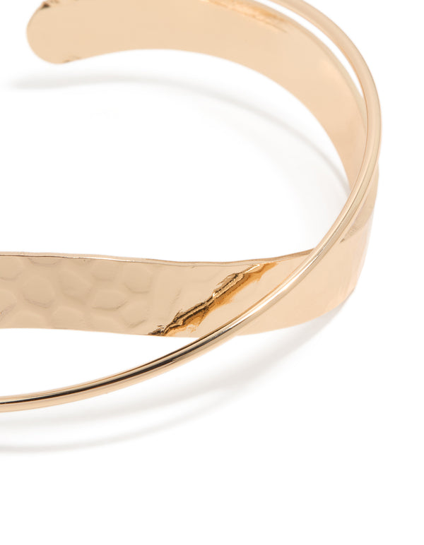 Featuring a gold twisted wrist cuff close up view