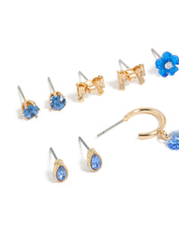 Elegantly designed gold blue diamante earrings 7-pack with flower and bow accents and stud closures close up view - link has visual effect only